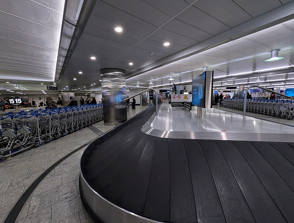 Bags moving along an airport baggage carousel