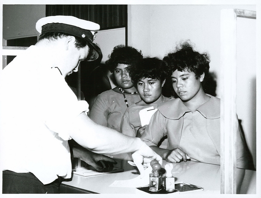 Customs officers inspecting travelers at an airport